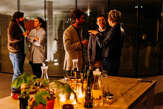 What is networking? An image of people socialising after hours in a coworking space, in an informal and pleasant setting.